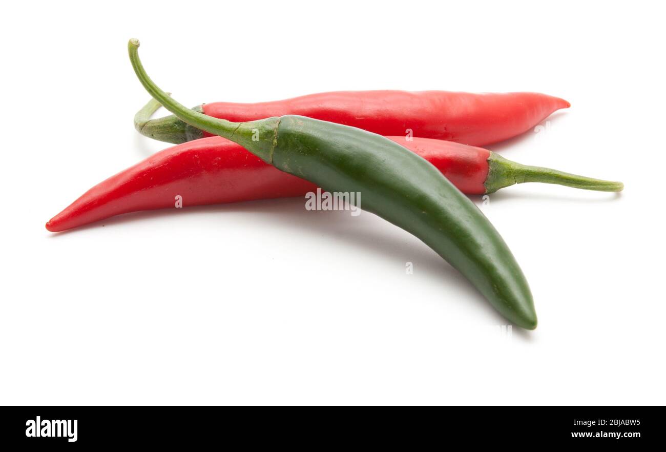 Red and green hot chili peppers isolated on white background closeup ...