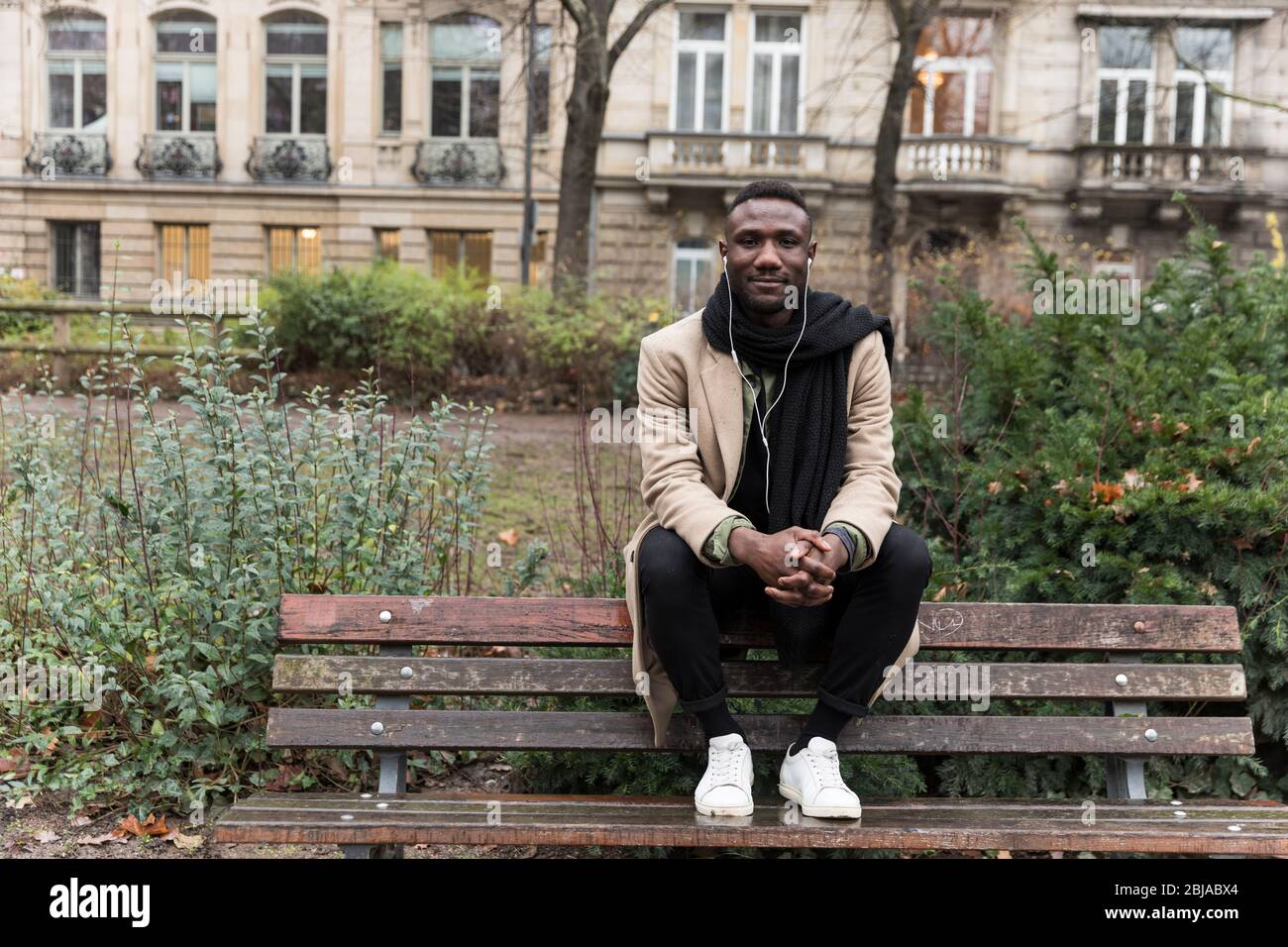 Young Black Man Sitting on Public Park Bench Backrest Stock Photo - Alamy