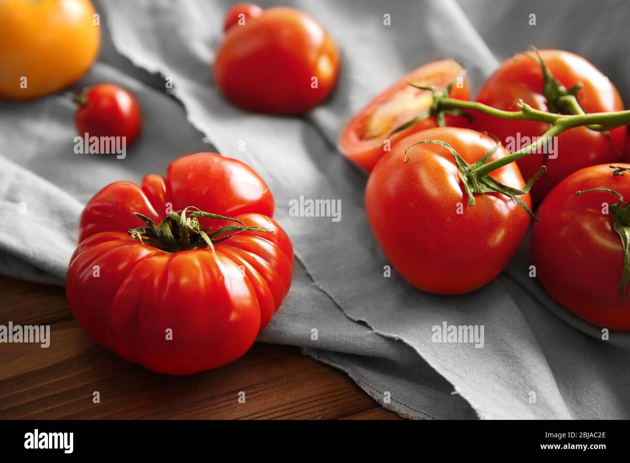 Rustic Tomato Color Rustic composition of tomatoes and cloth, close up Stock Photo - Alamy