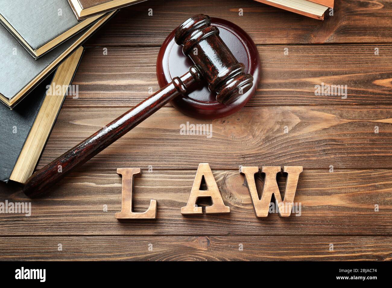 Word law with judges gavel and legal books on wooden background Stock Photo  - Alamy