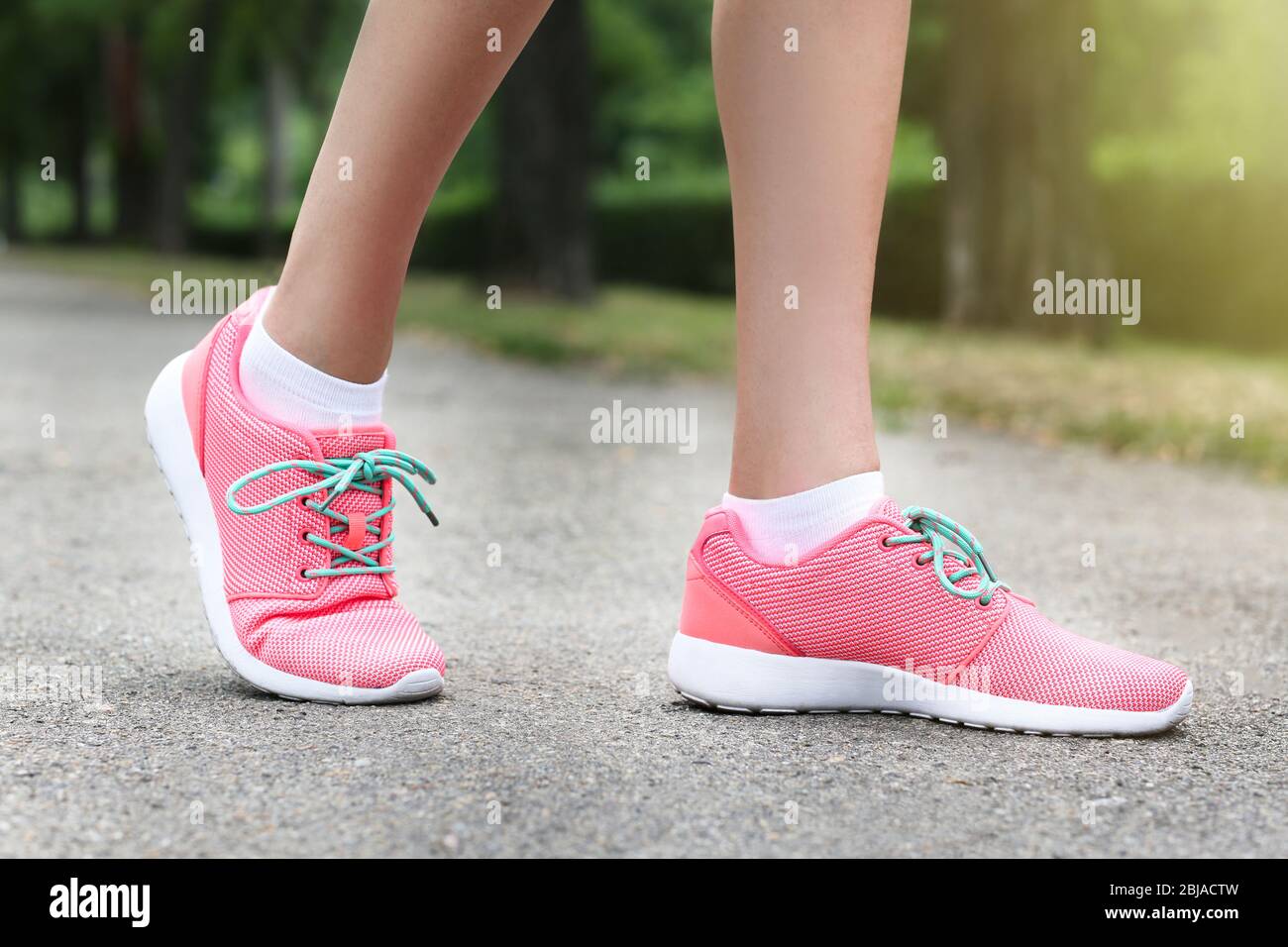 Woman wearing pink sneakers Stock Photo - Alamy