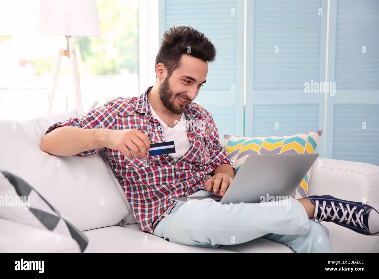 Handsome man using credit bank hi-res stock photography and images - Alamy