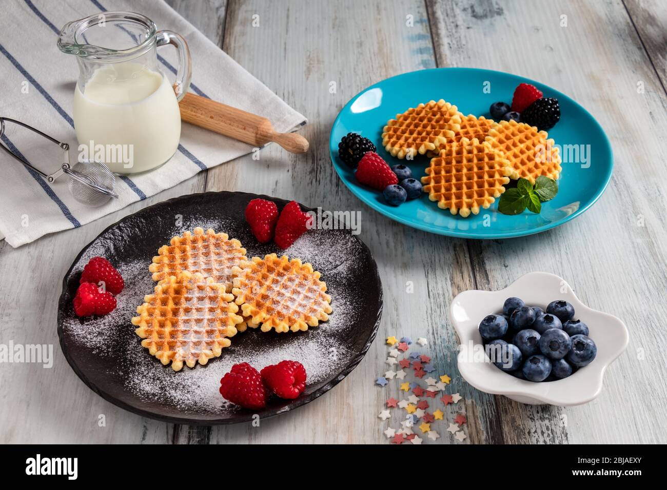 Traditional Belgian waffles with fresh fruit and milk. Rustic kitchen table Stock Photo - Alamy