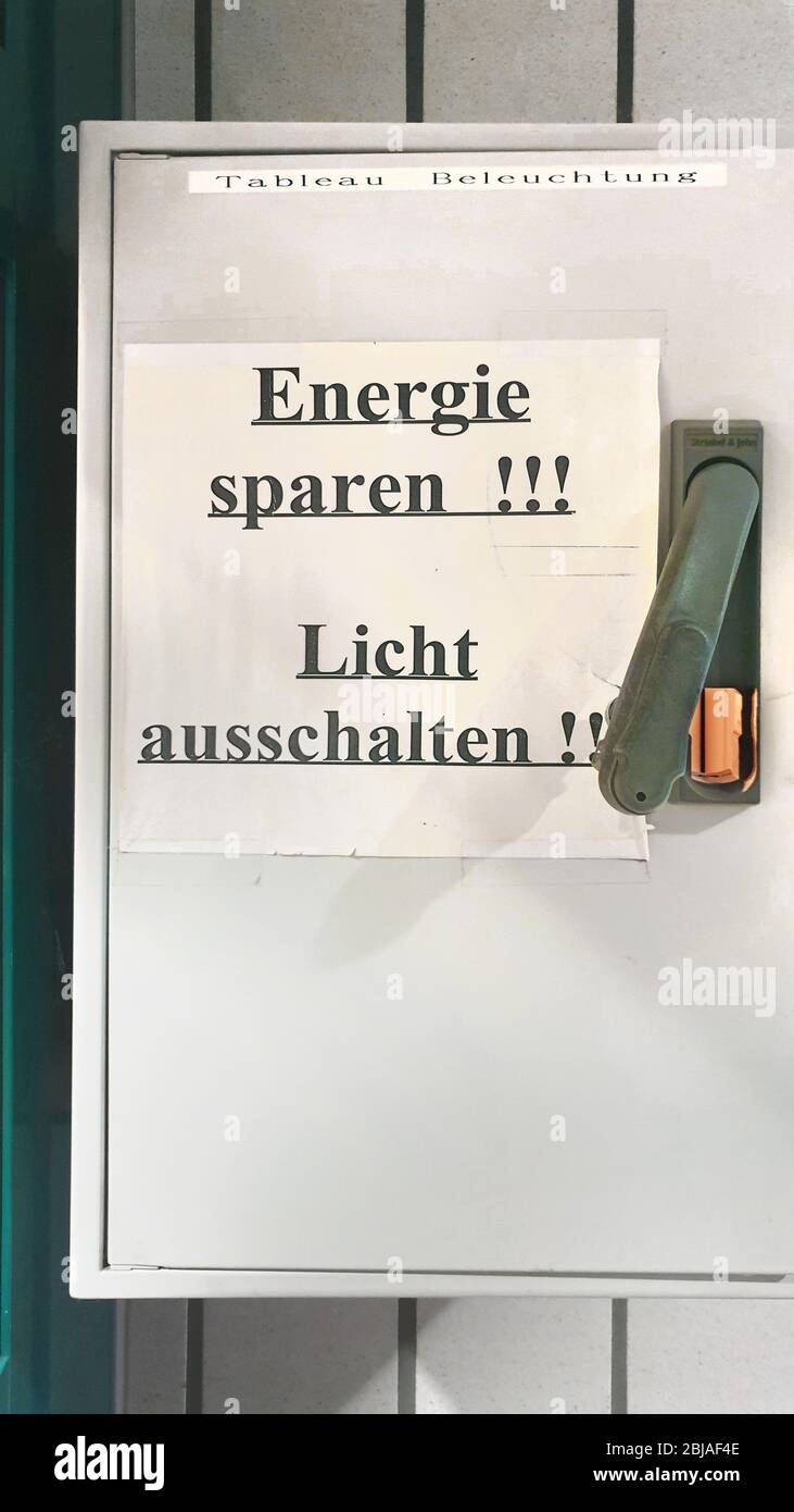 sheet of paper lettering 'save energy, switch of the light' on the switch box for lights, Germany Stock Photo