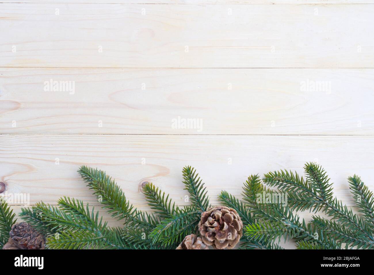 christmas background fir leaves and pine cones decorating on white wood ...