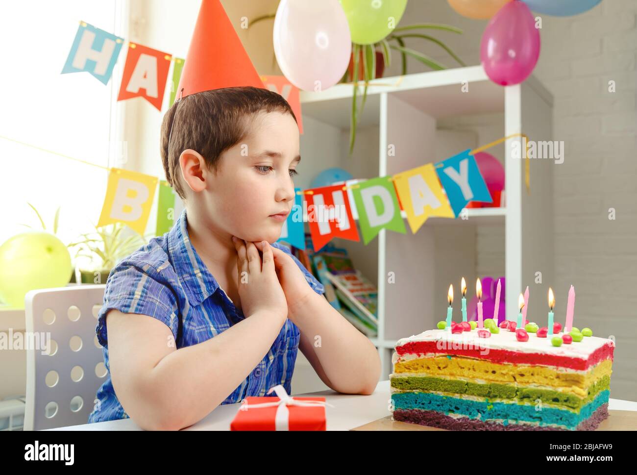 Happy boy with funny face near birthday cake. Birthday party and ...