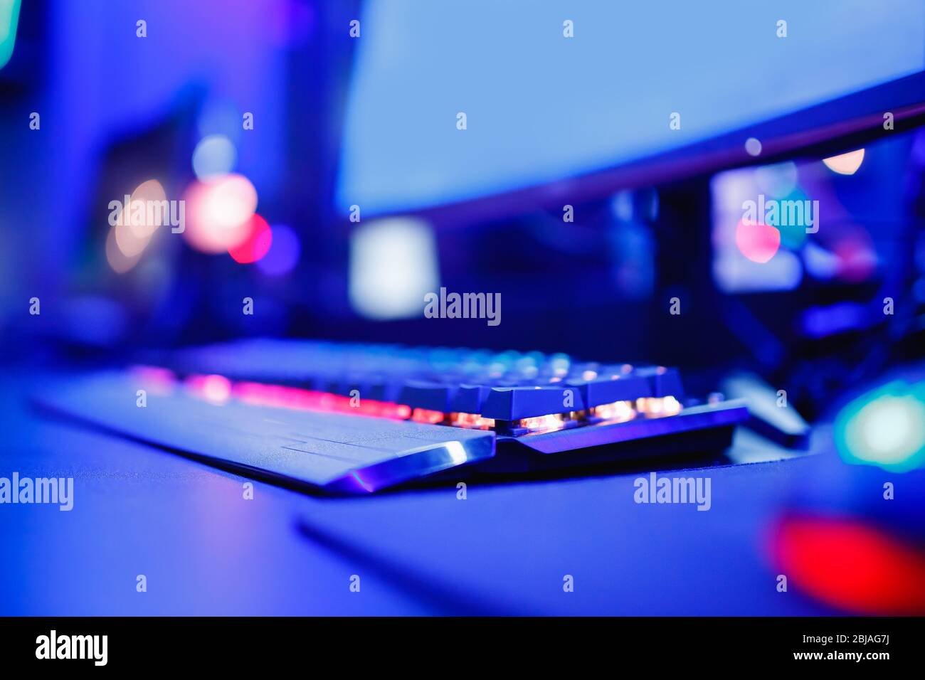 Blurred background professional gamer playing tournaments online games  computer with headphones, red and blue Stock Photo - Alamy