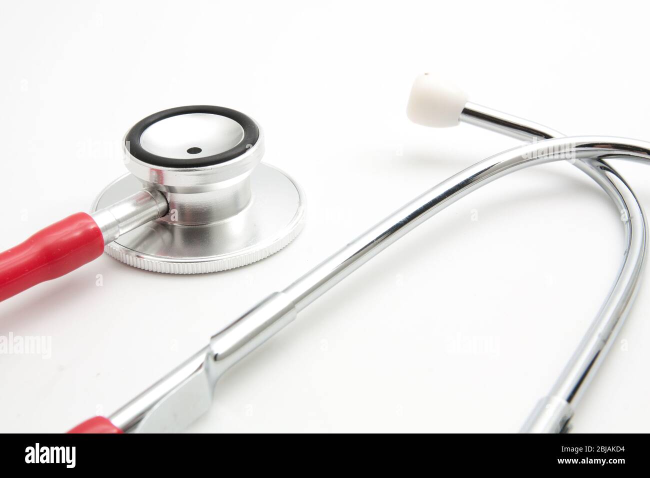 Close -up red stethoscope on white background Stock Photo - Alamy