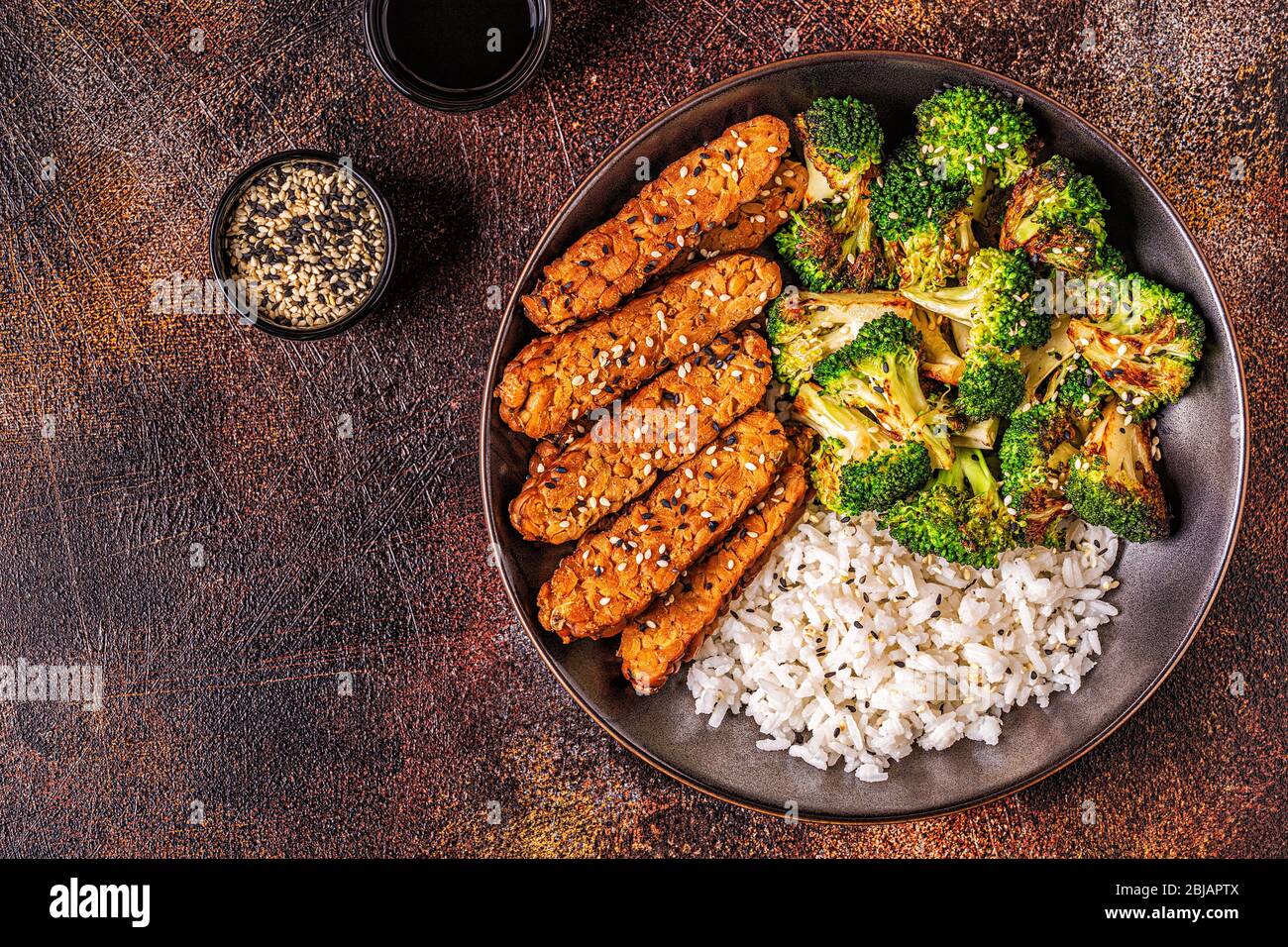 Fried tempeh with rice and broccoli, traditional indonesian cuisine