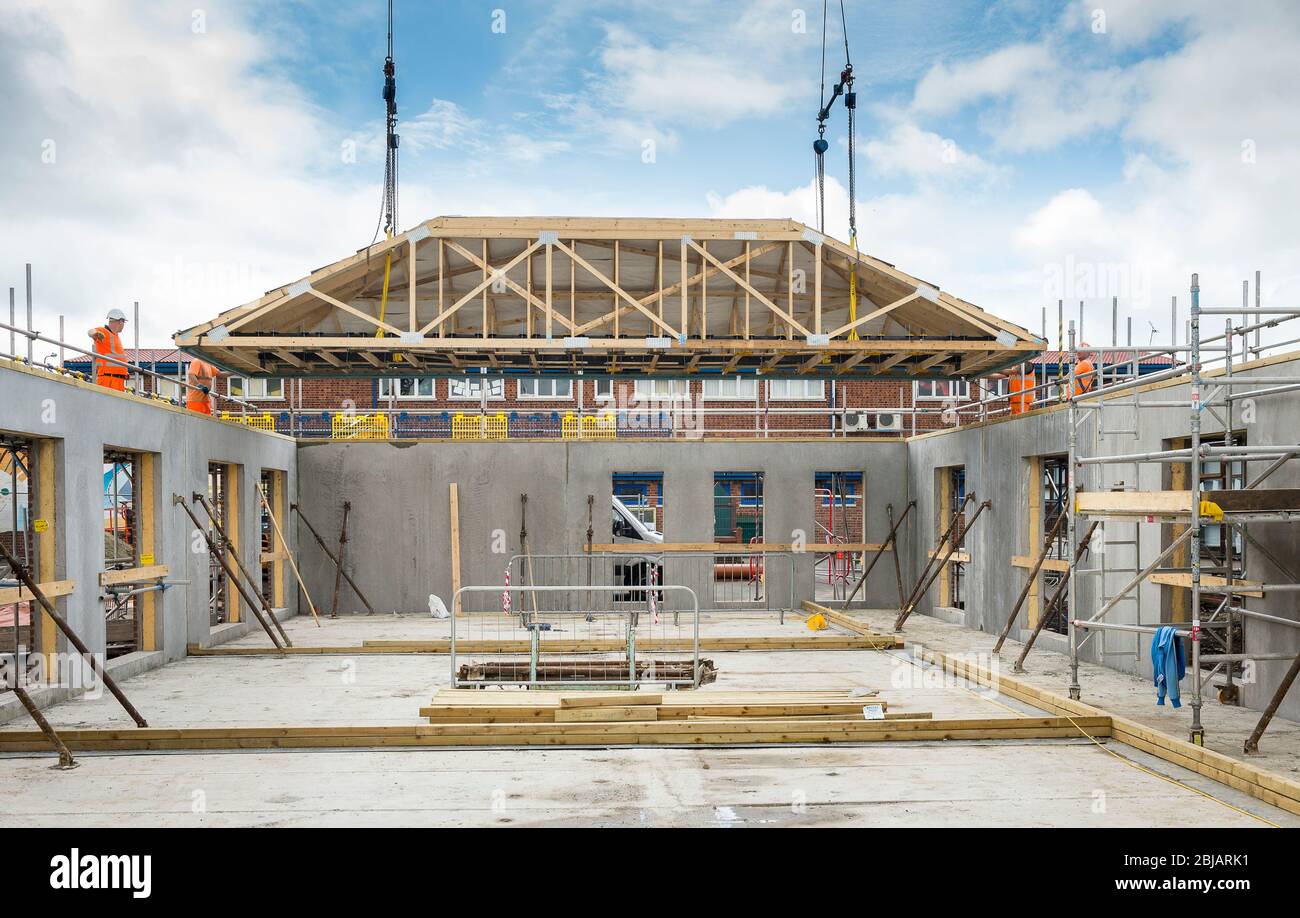 Lowering roof joists onto a building under construction on a building