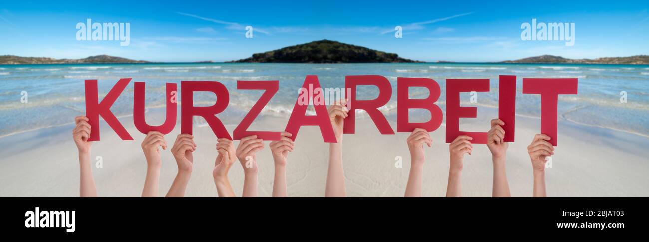People Hands Holding Word Kurzarbeit Means Short-Time Work, Ocean Background Stock Photo