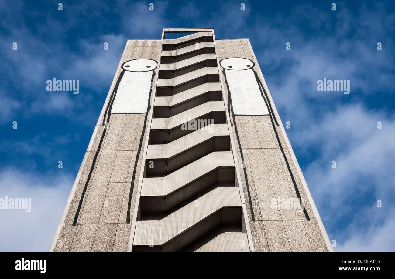 Stik graffiti of a stick figure on the side of a high rise building in England. Stock Photo
