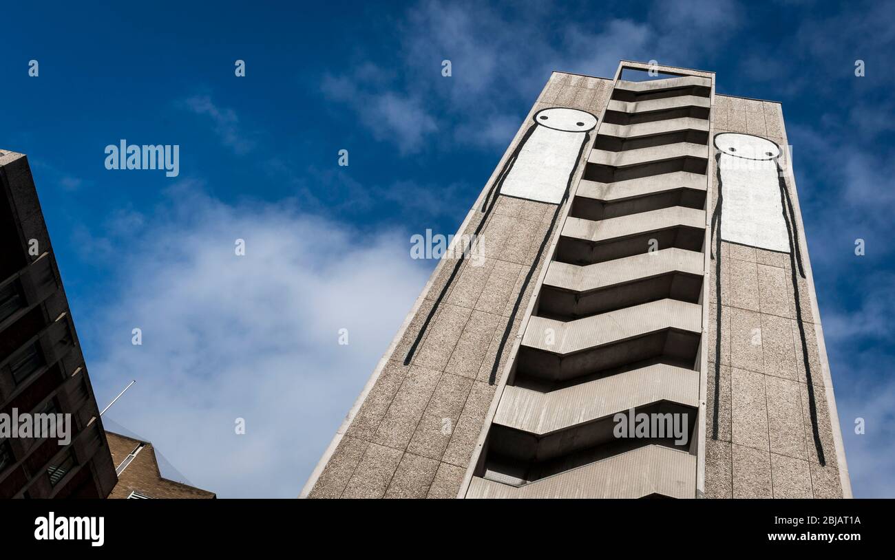 Stik graffiti of a stick figure on the side of a high rise building in England. Stock Photo