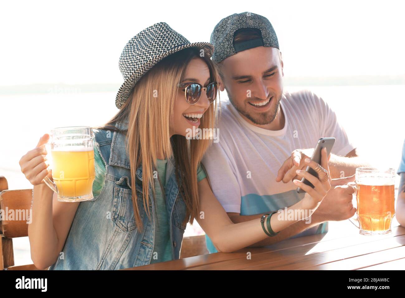Group of friends hanging out together outdoors Stock Photo - Alamy