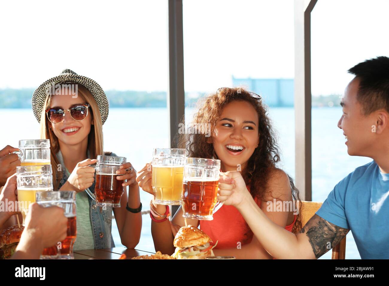 Group of friends hanging out together outdoors Stock Photo - Alamy