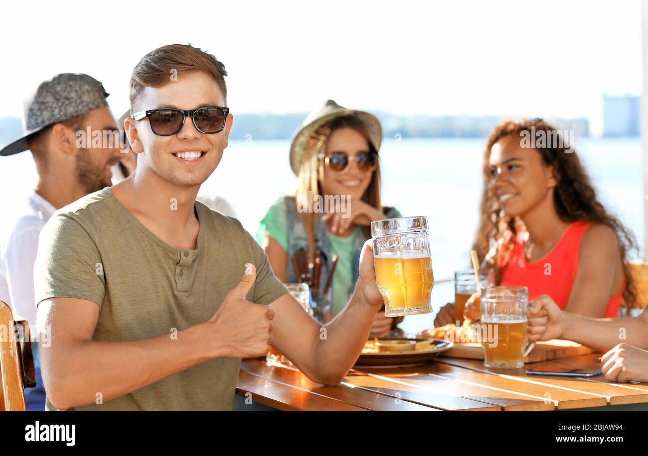 Group of friends hanging out together outdoors Stock Photo - Alamy