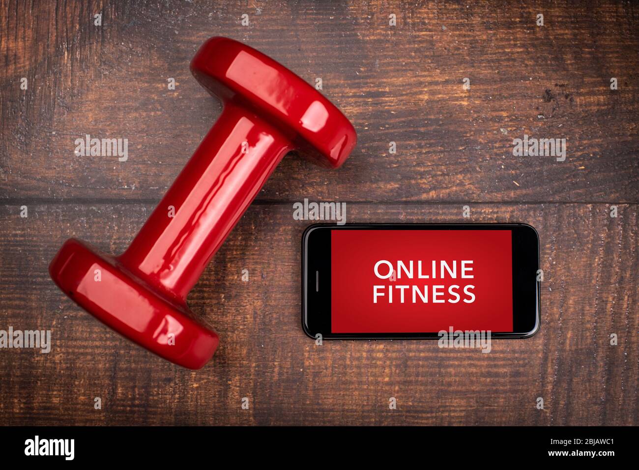 Red dumbbell and smartphone on a woodan background. App for training indoors. Online Fitness program. Home online workout. Top view Covid 19 Coronavi Stock Photo Alamy