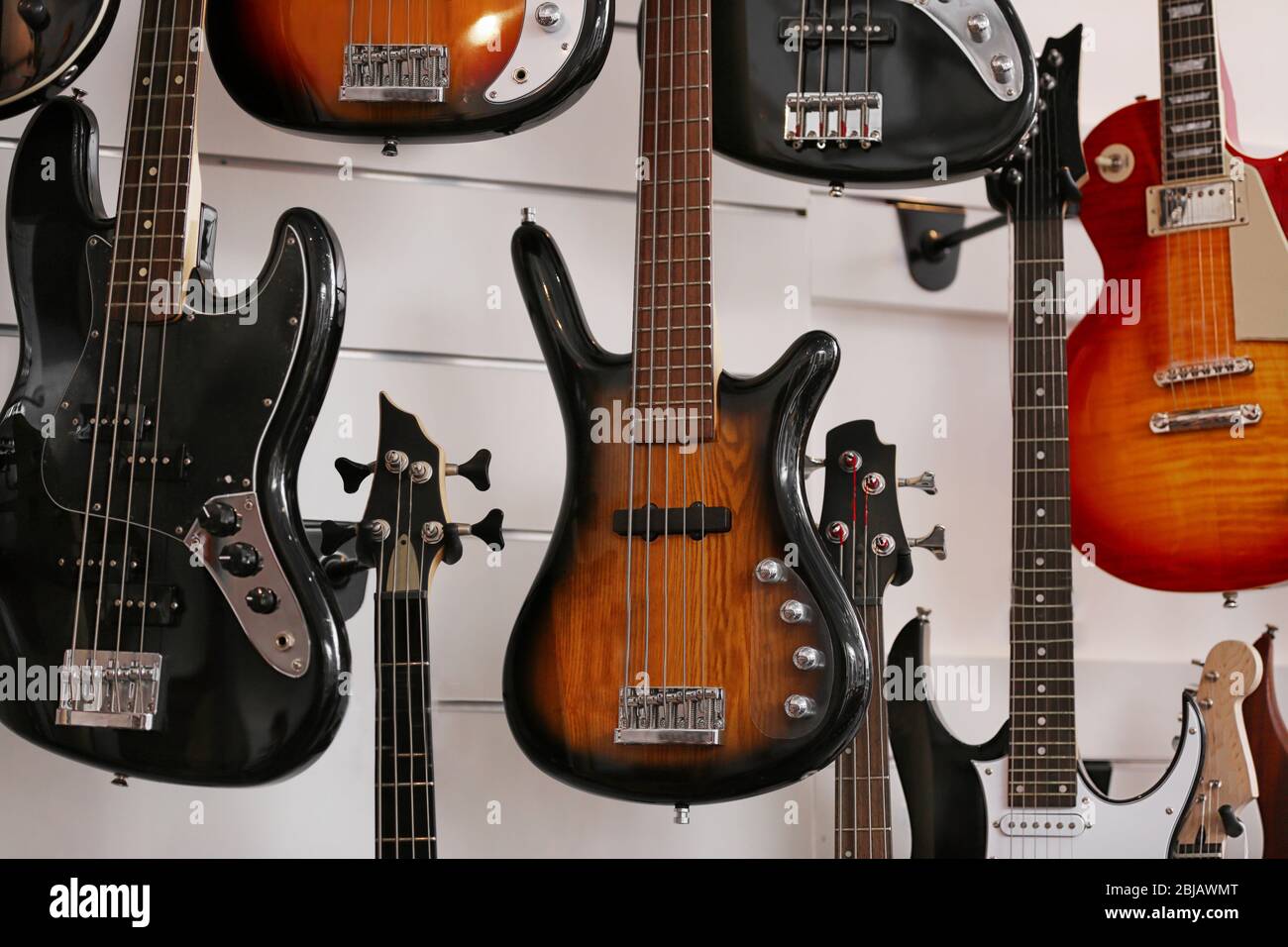 Guitars hanging on wall, closeup Stock Photo Alamy