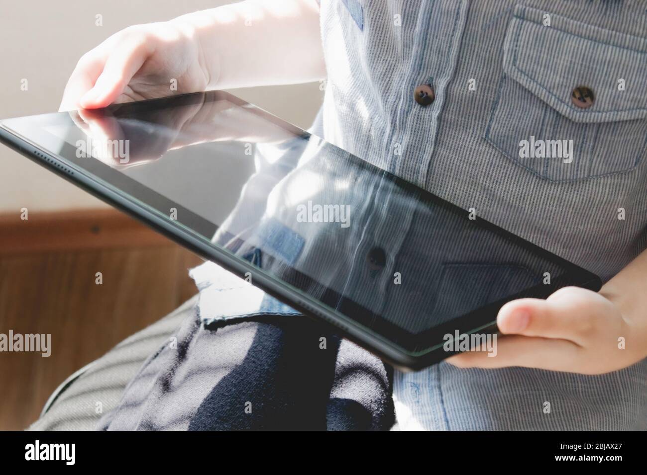 The child is learning distance learning lessons on a tablet. Home ...