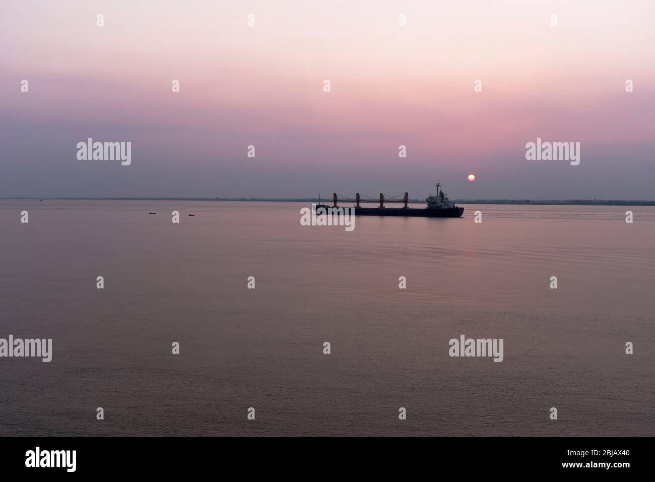 dh Far east Asia YANGON RIVER MYANMAR Sunset over Merchant Navy cargo ship asian shipping vessel far east Stock Photo