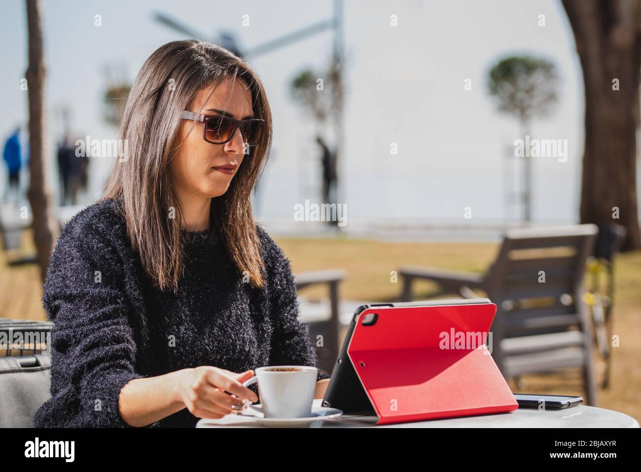 Beautiful young woman having Zoom video conference call via tablet