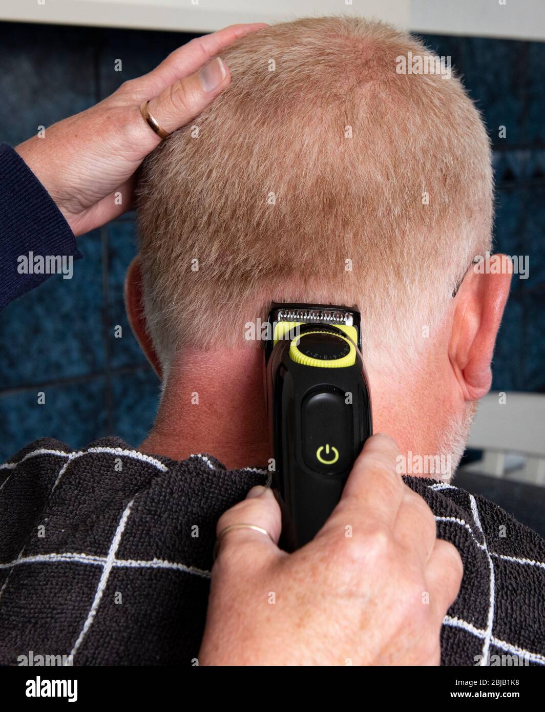 Hair trimmers being used at home to trim hair Stock Photo