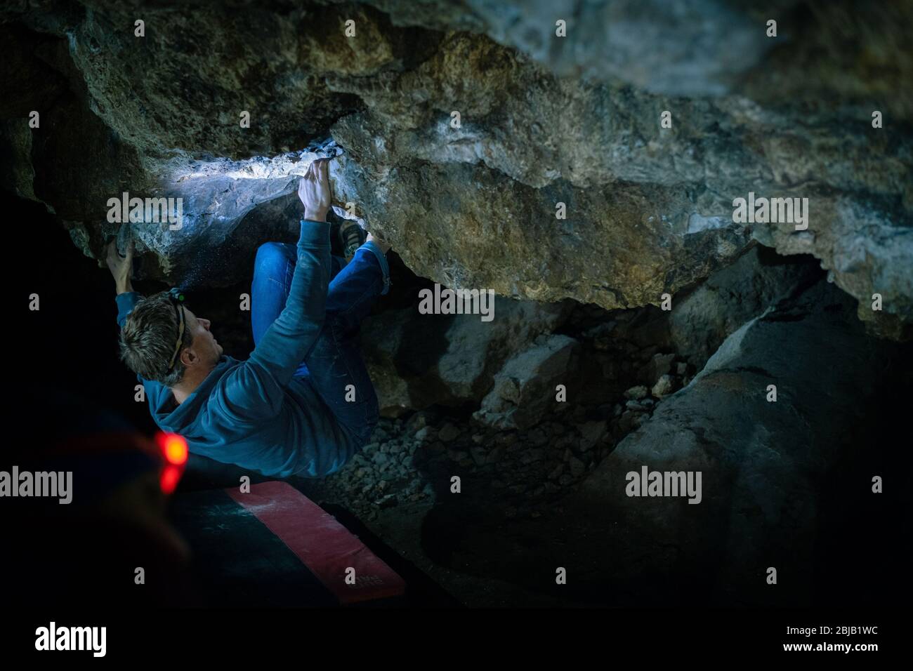 Man is making a boulder in Twardowski cave. Bouldering in rock. Twardowski Cave Stock Photo