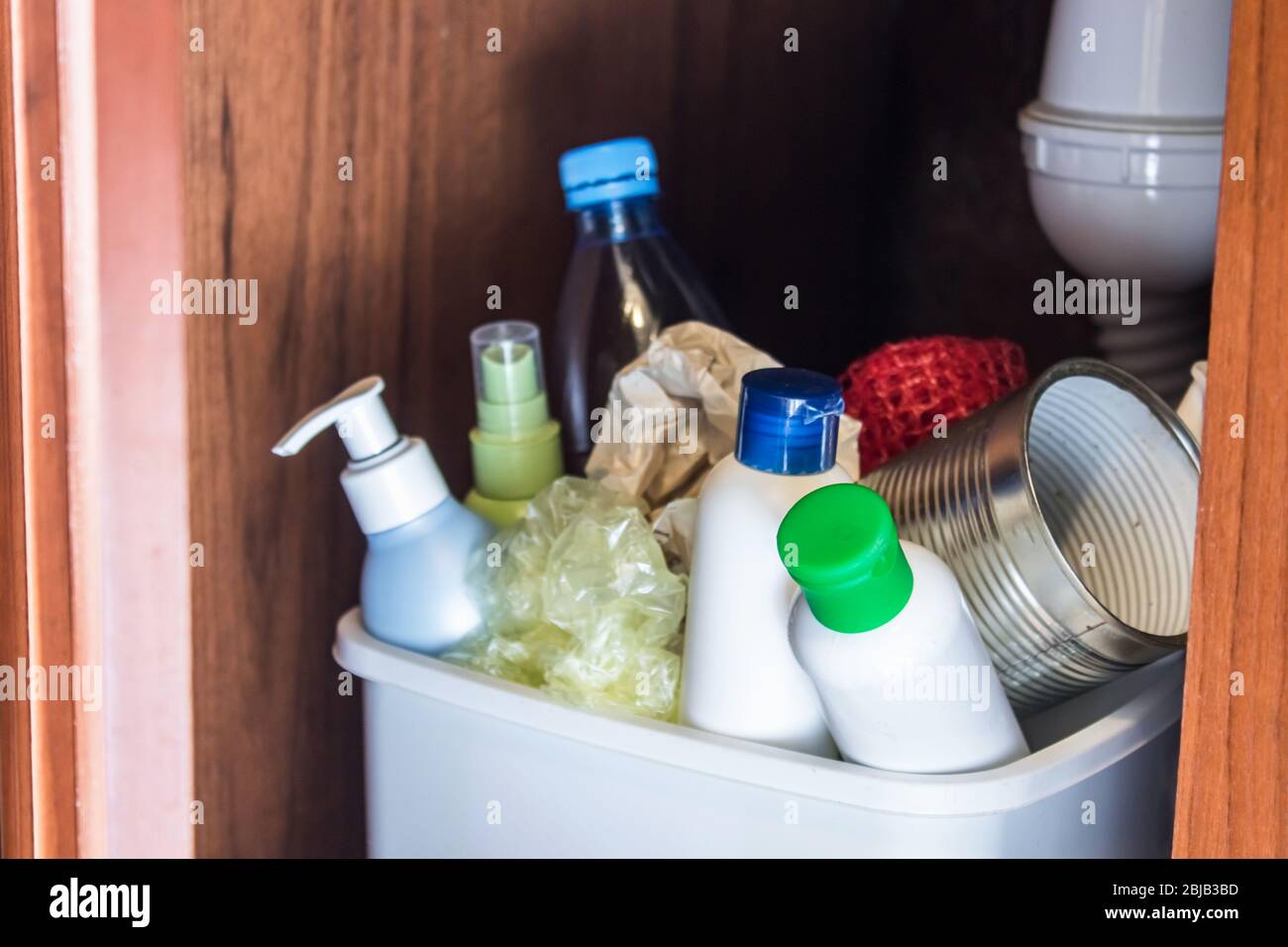 Plastic trash can in the kitchen bottles, plastic and metal
