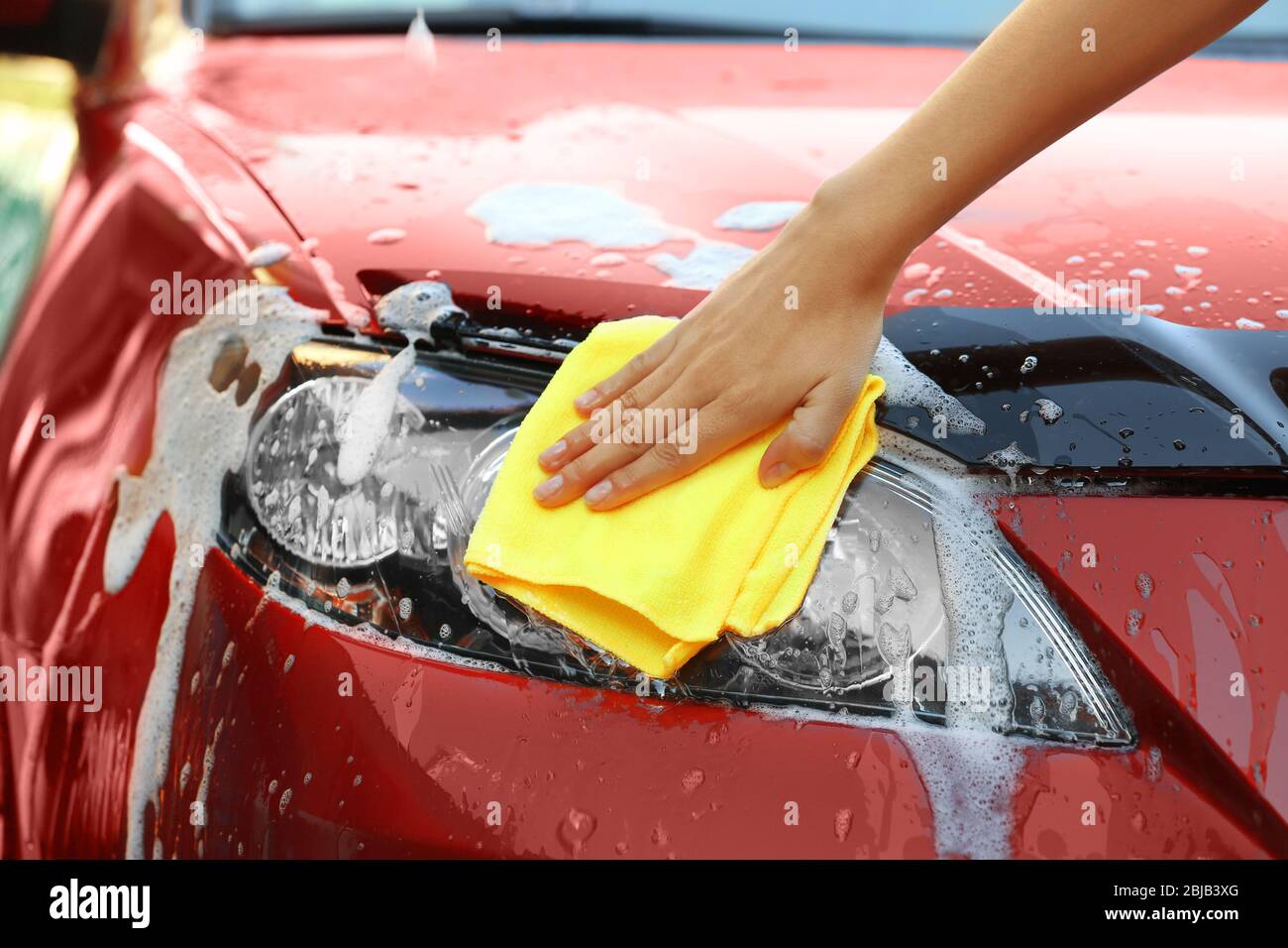 Servicewoman washing a car Stock Photo