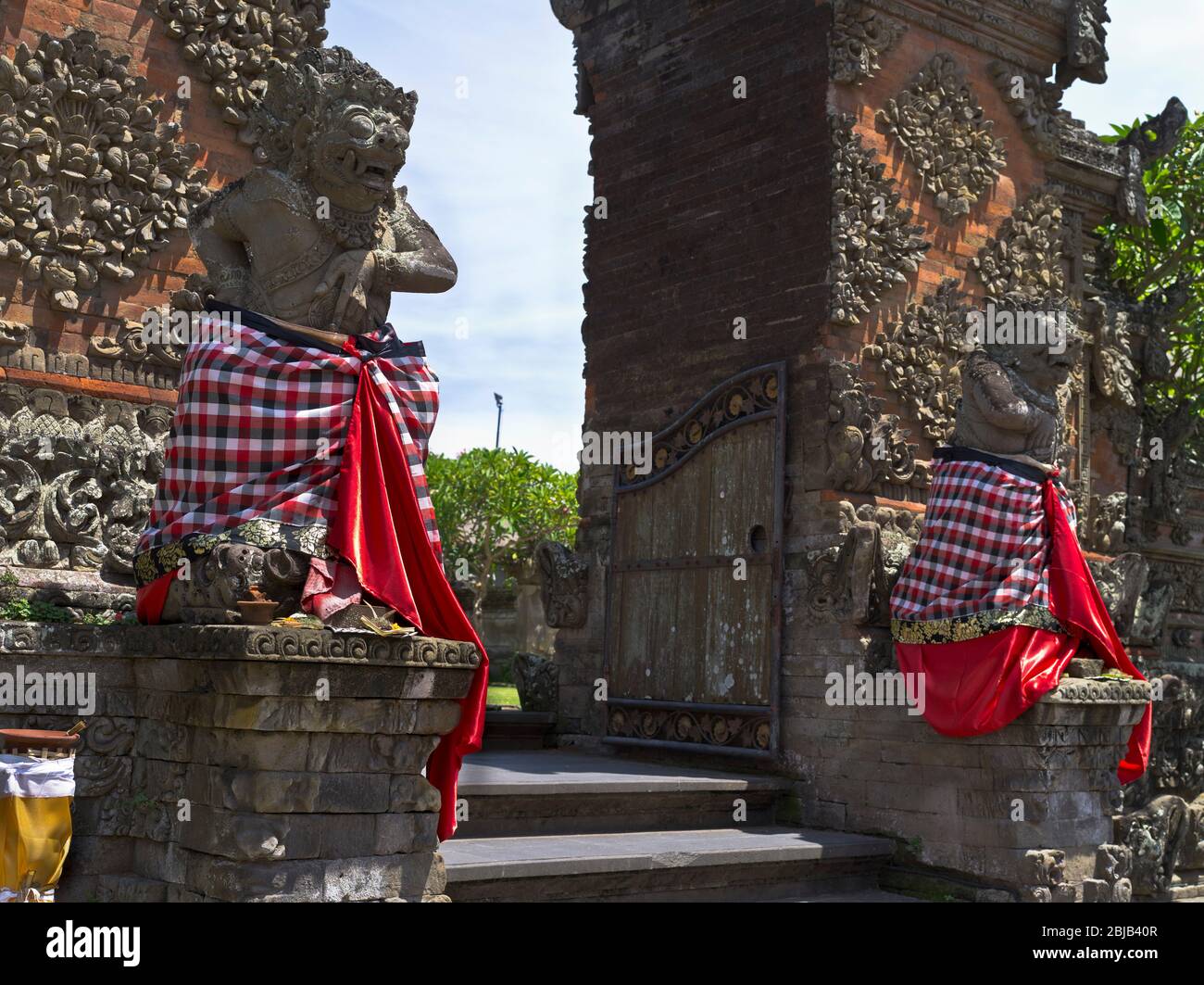 dh Balinese Batuan temple gods BALI INDONESIA Traditional Hindu gate guards statues guard entrance to guardians hinduism Stock Photo