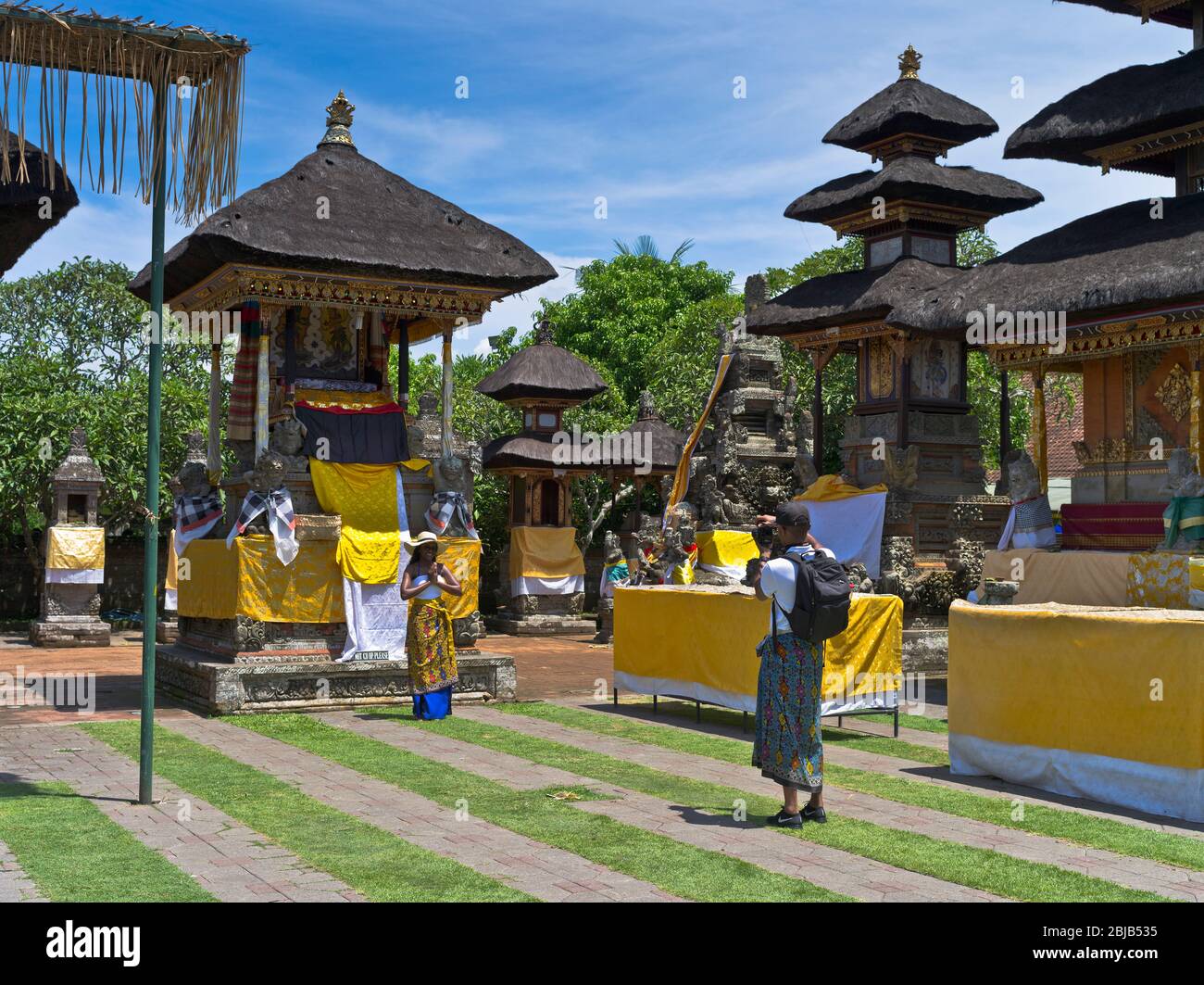 dh Balinese Batuan temple BALI INDONESIA Hindu temples tourists photo traditional dress code hinduism inner sanctum tourist photographing Stock Photo