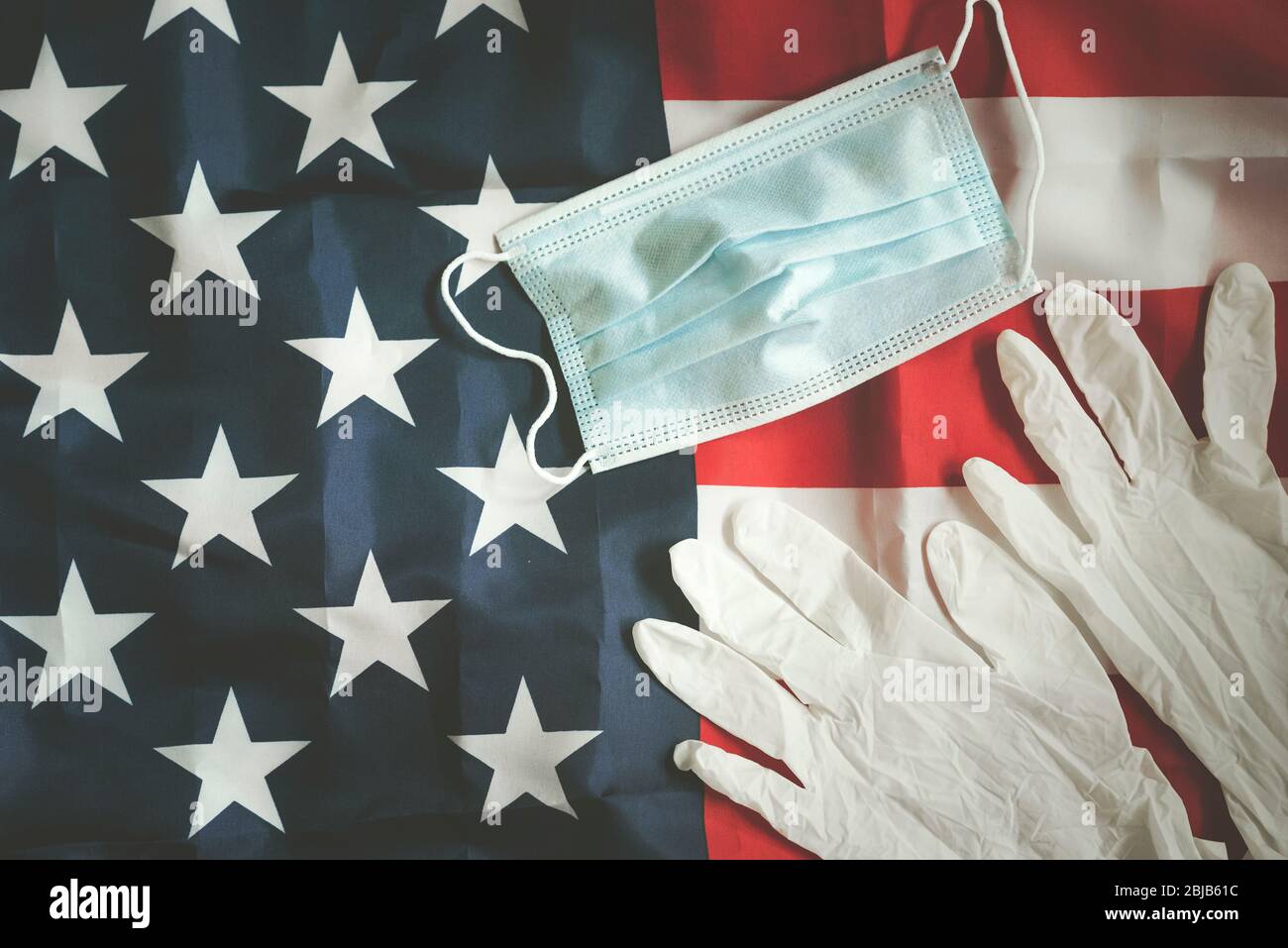 Coronavirus, American flag with medical mask and medical gloves, background Stock Photo