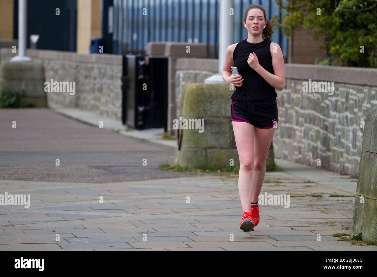 Runner with both feet off ground hires stock photography and images