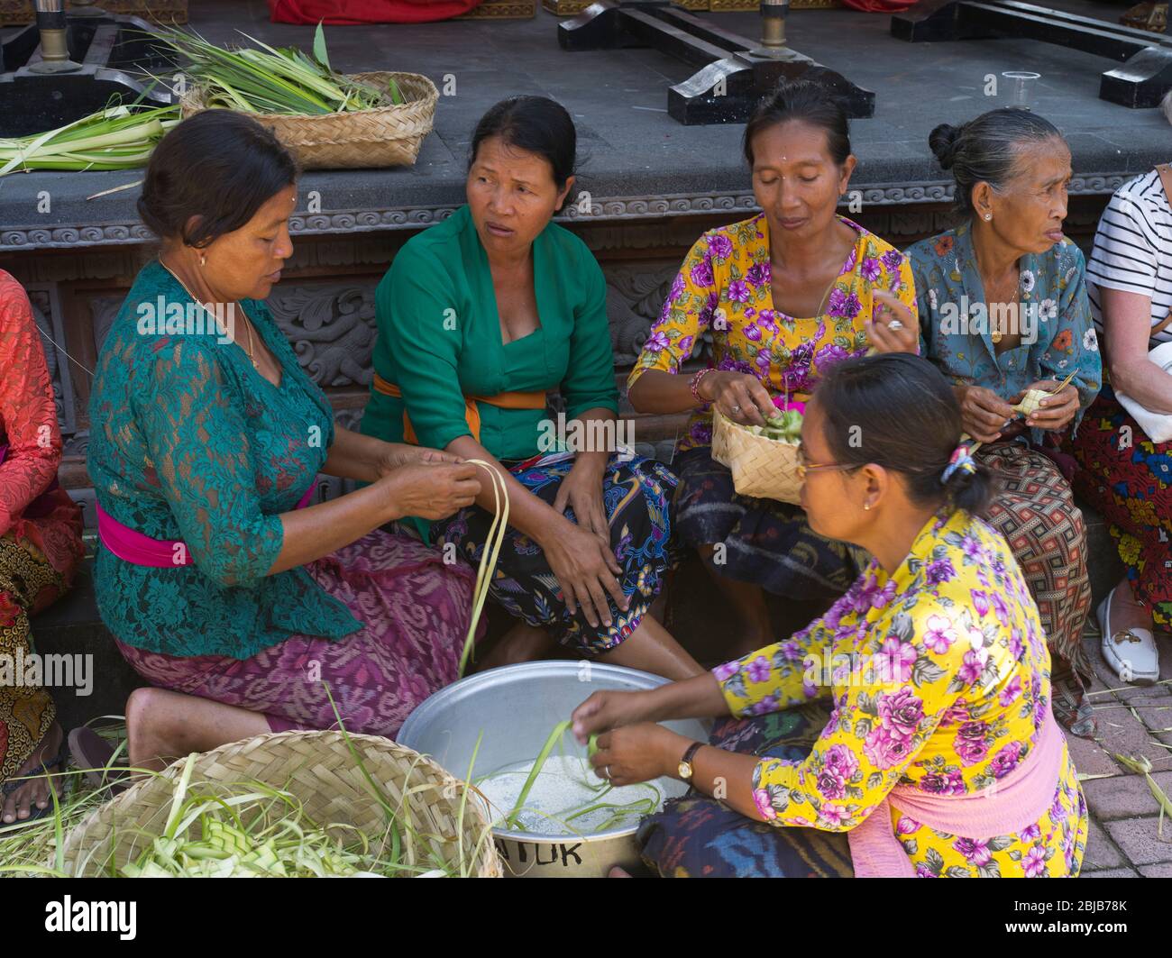dh Balinese Batuan temple Asia BALI INDONESIA Group Hindu women making tipat rice packages asian indonesian Ketupat people Stock Photo