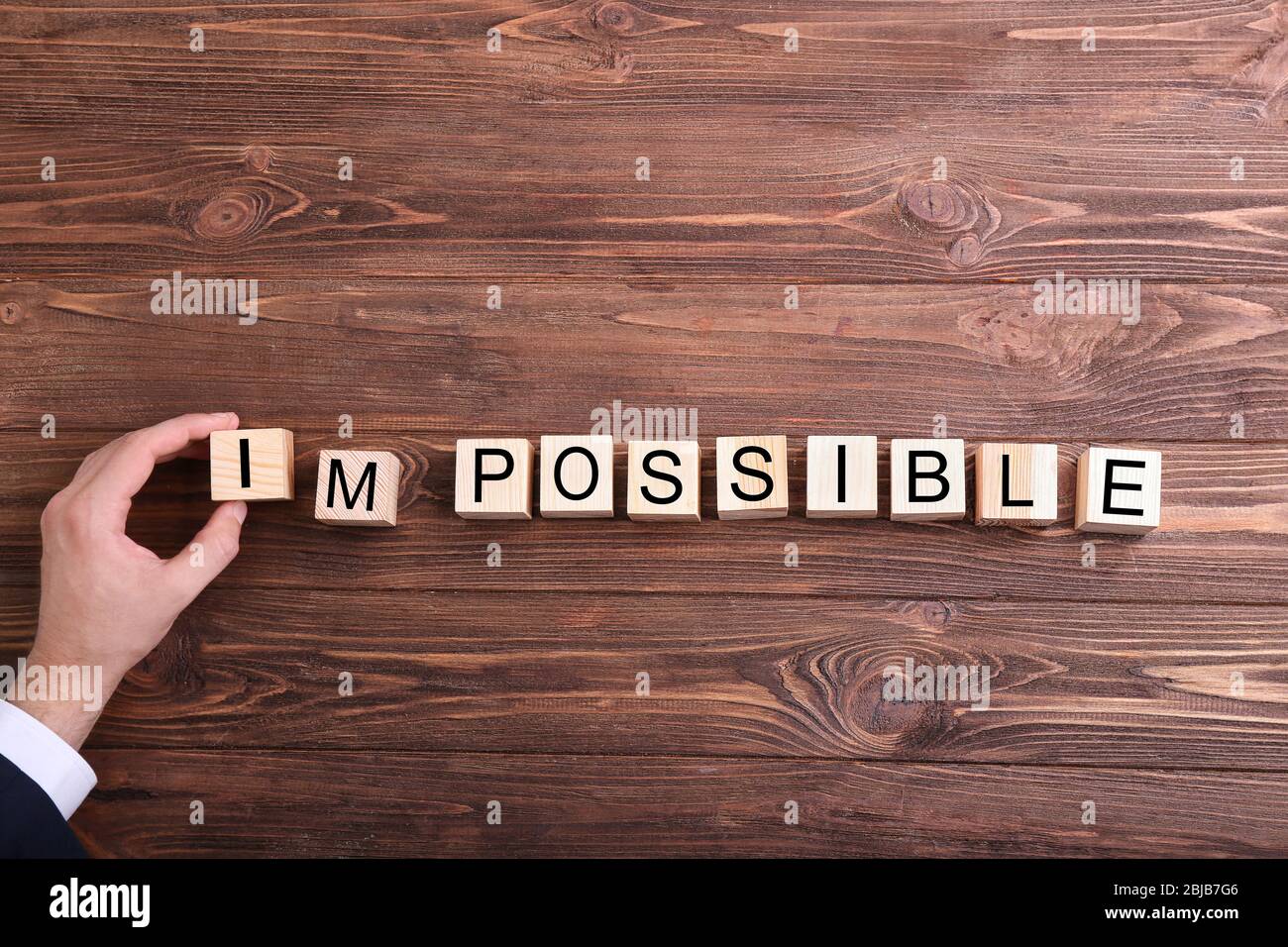 Human hand turning word impossible into possible Stock Photo