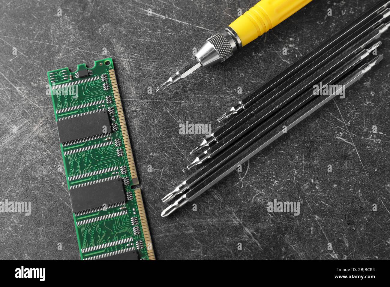 RAM memory, screwdriver and exchangeable bits on grey background Stock Photo