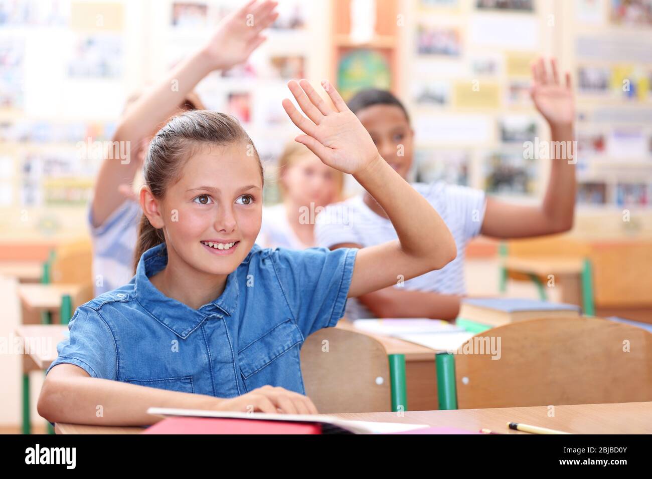 Cute schoolgirl in classroom on lesson Stock Photo - Alamy