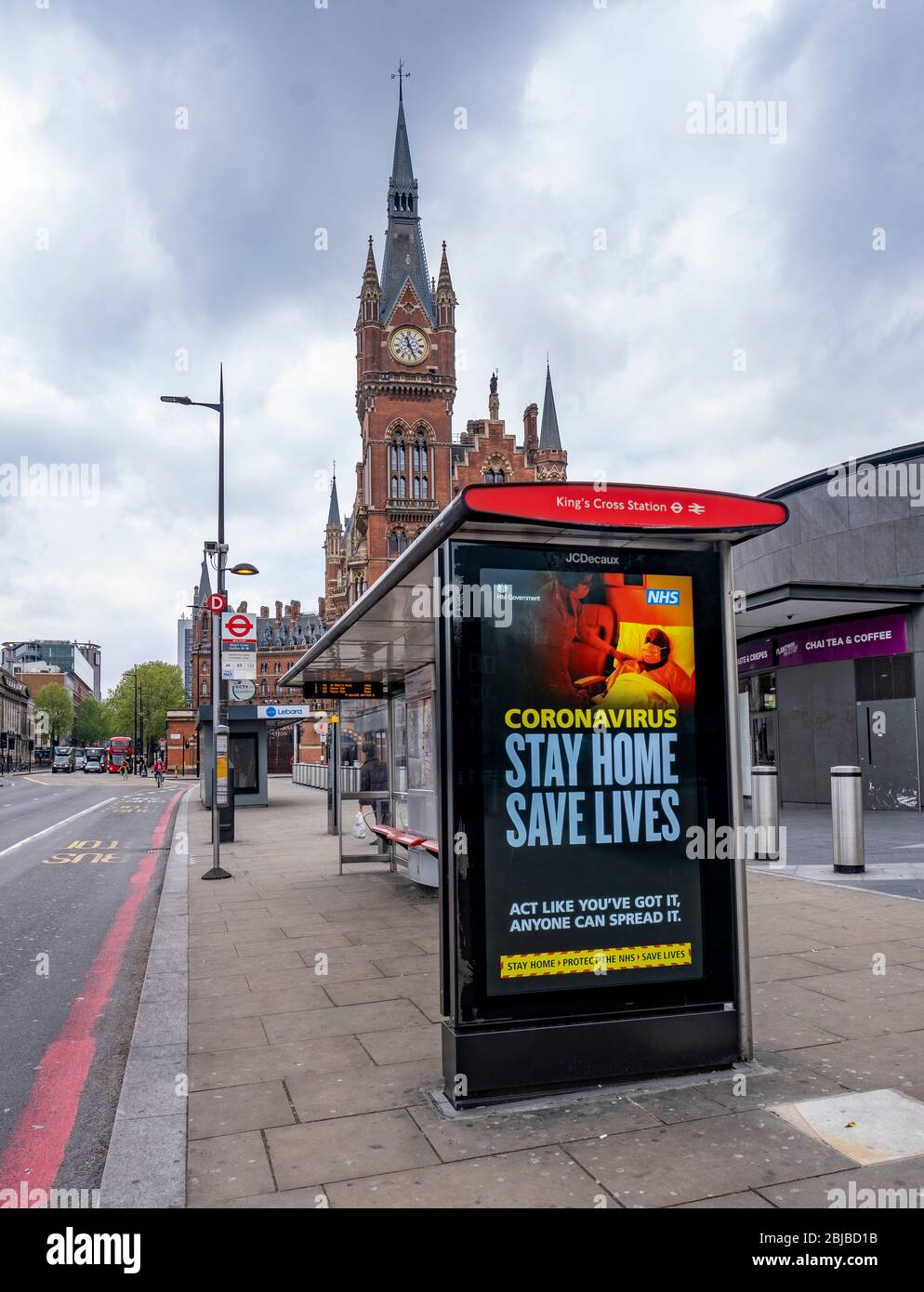 Lockdown London, April 29th 2020: Kings Cross Station, empty Euston Road, an advertising hoarding with an advert to advise people to stay at home Stock Photo
