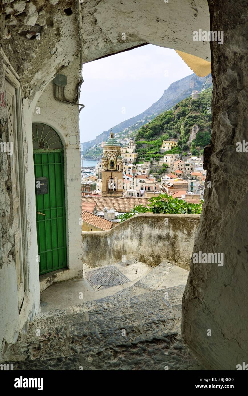 Amalfi village with bell tower from archway on stairs of typical labyrinth of narrow street Stock Photo