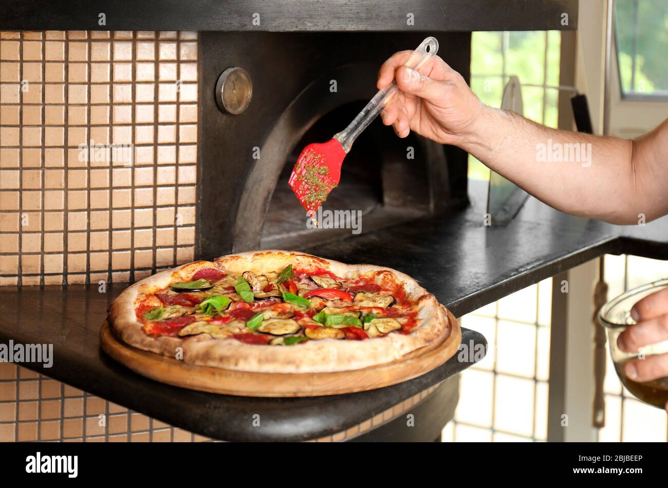 Tasty baked pizza near oven Stock Photo Alamy