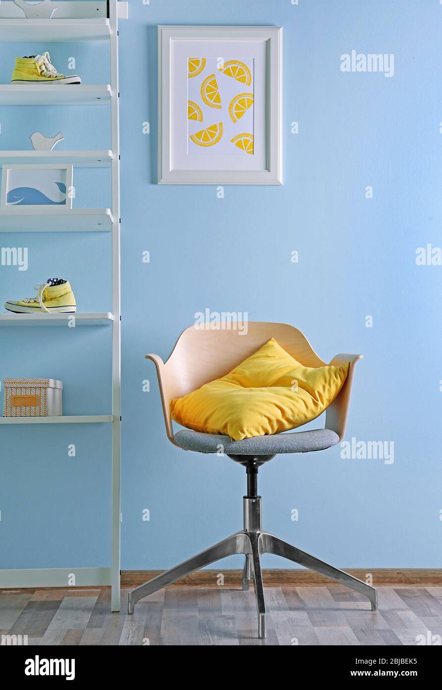 Simple interior with stool and decorations on blue wall background
