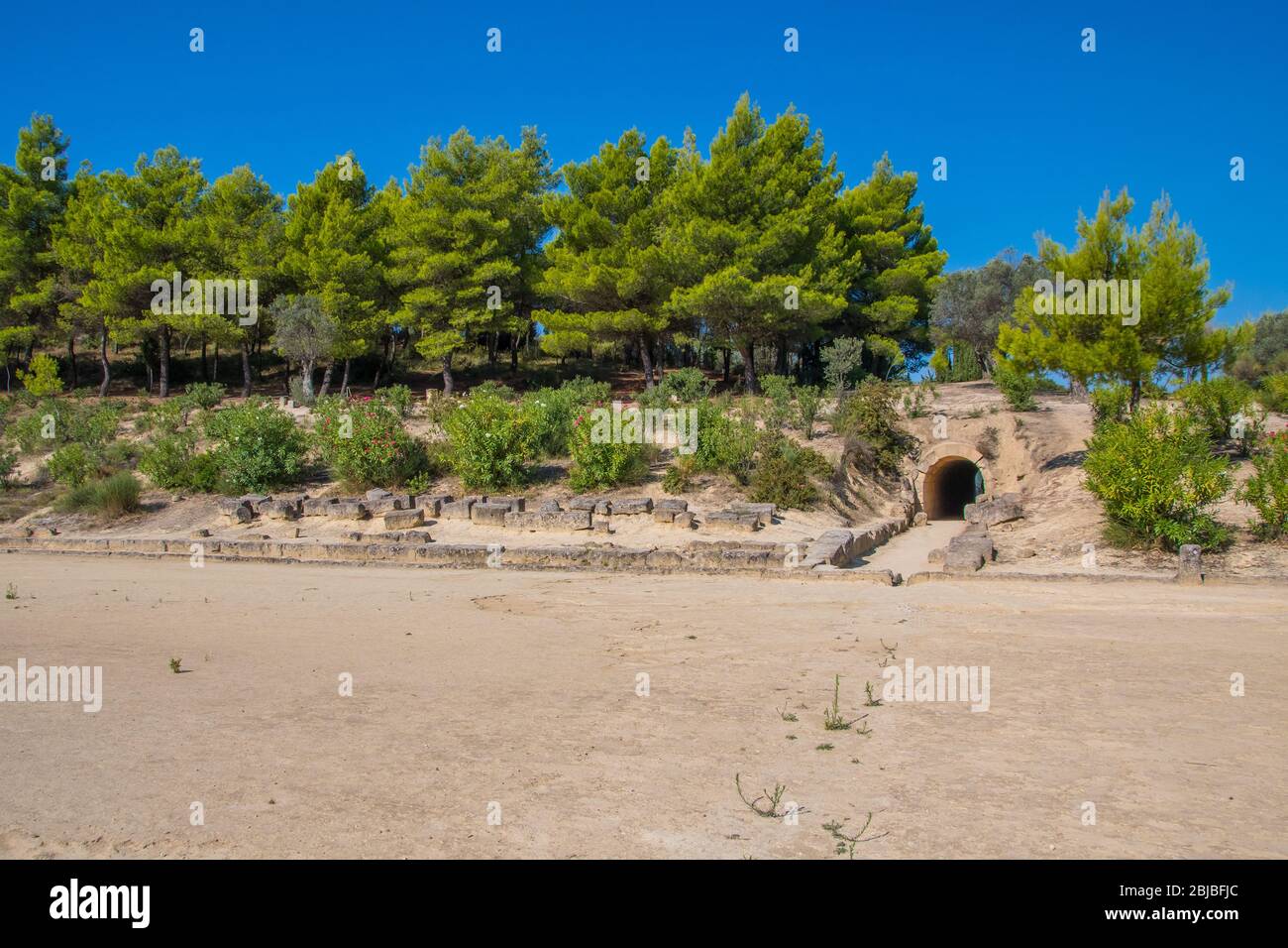 Stadium of the Panhellenic Games and the entrance tunnel from where the athletes enter to the stadium at archaeological site of Nemea in Greece Stock Photo