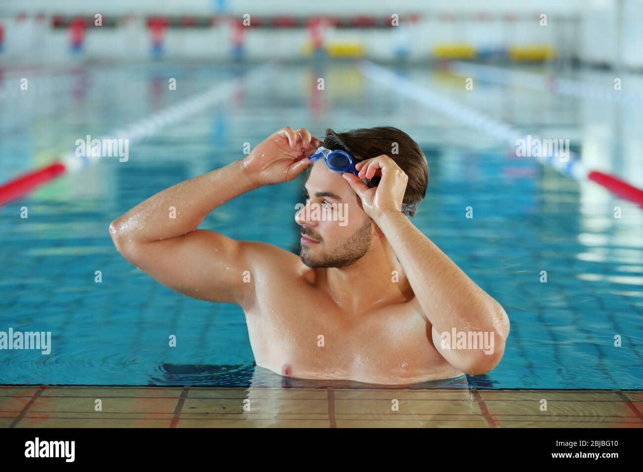 Young man in swimming pool hi-res stock photography and images - Alamy
