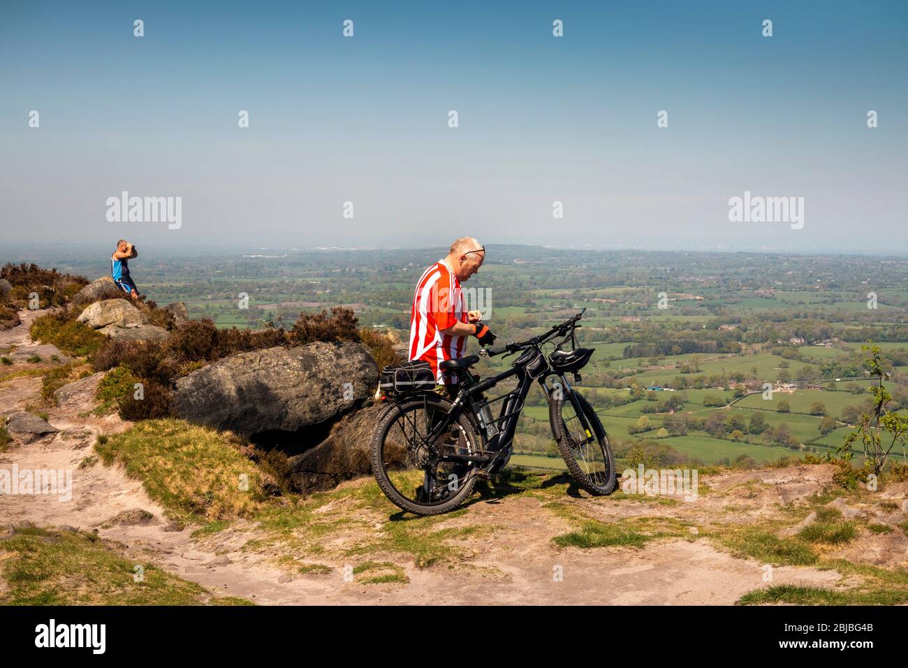 UK, England, Cheshire, Congleton, mountain biker and walker at the summit of Bosley Cloud Stock Photo