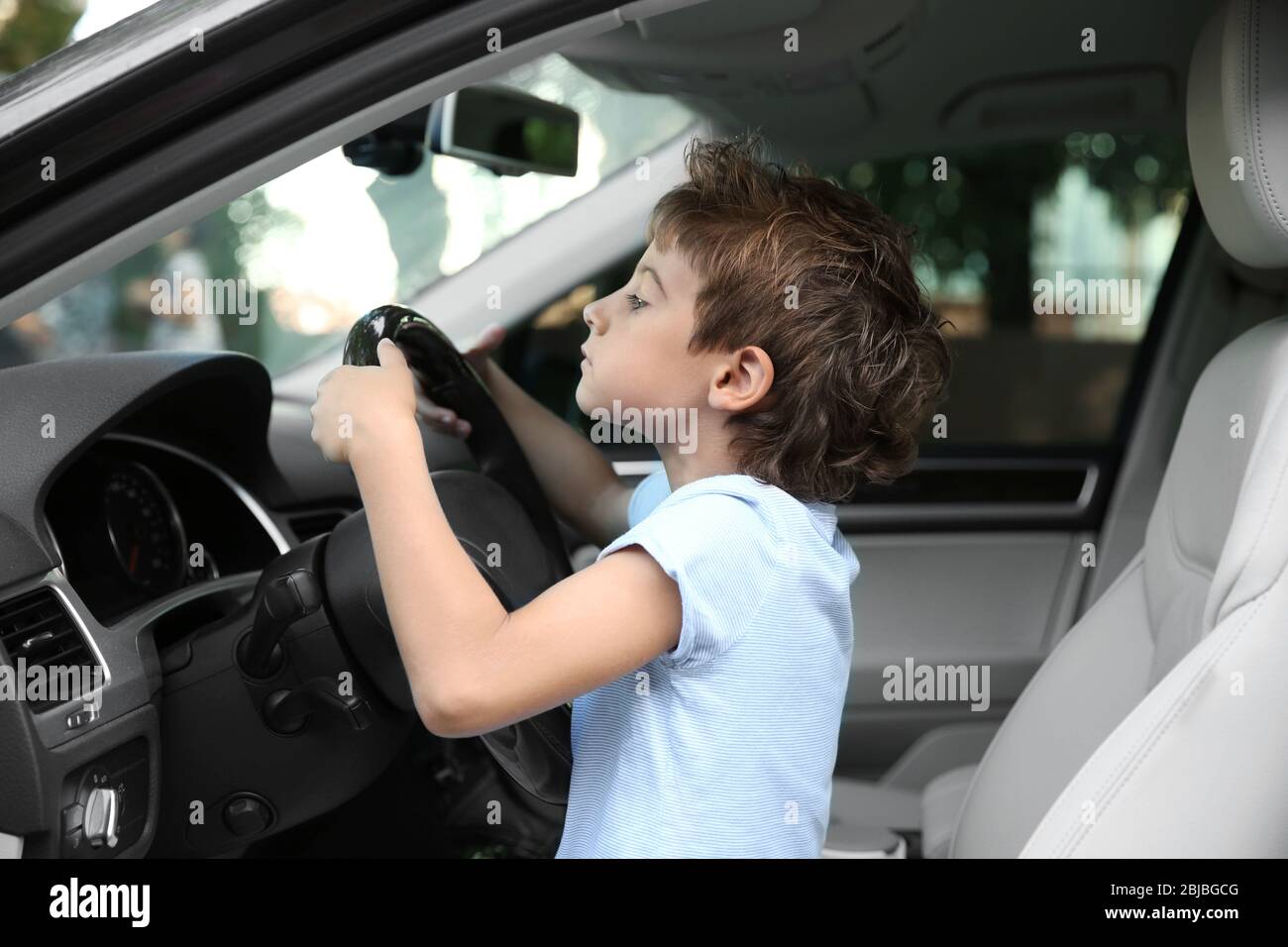 Boy driving parent car Stock Photo Alamy