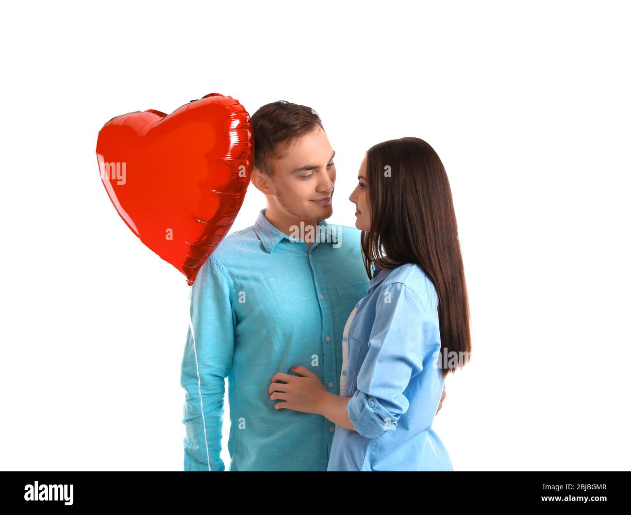 Happy couple with red balloon on white background Stock Photo - Alamy