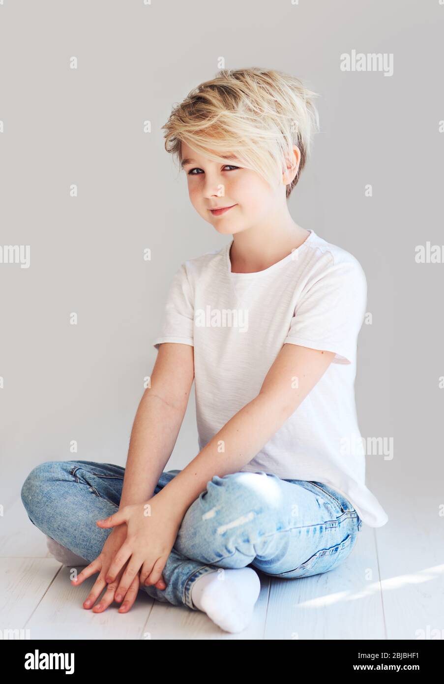 handsome teenager boy sitting on the floor Stock Photo - Alamy