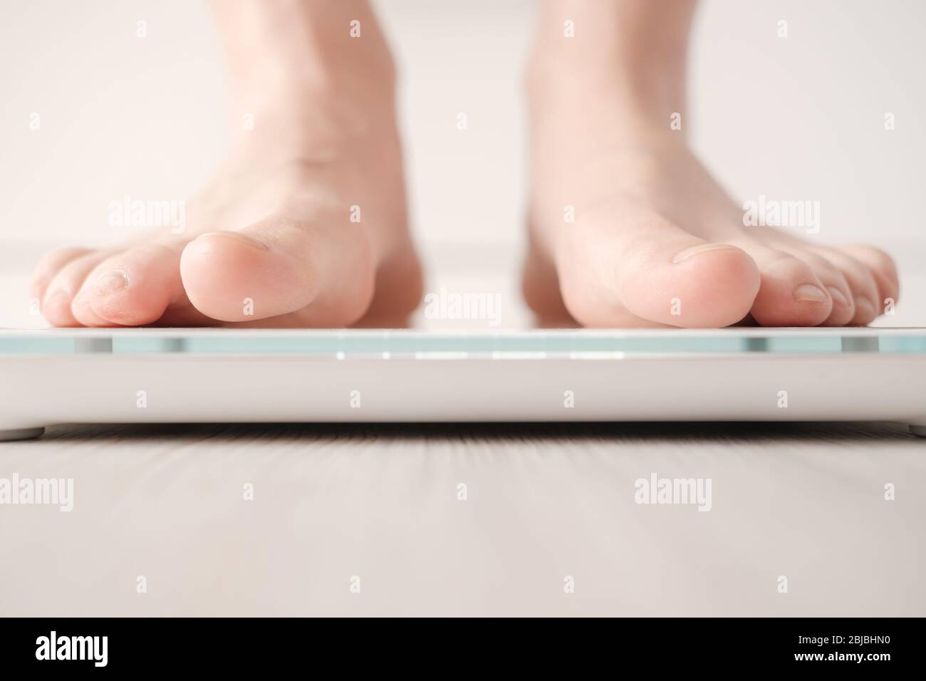 Bare feet stand on smart scales that makes bioelectric impedance analysis,  BIA, body fat measurement. Stock Photo by ©akoldunov 369502604