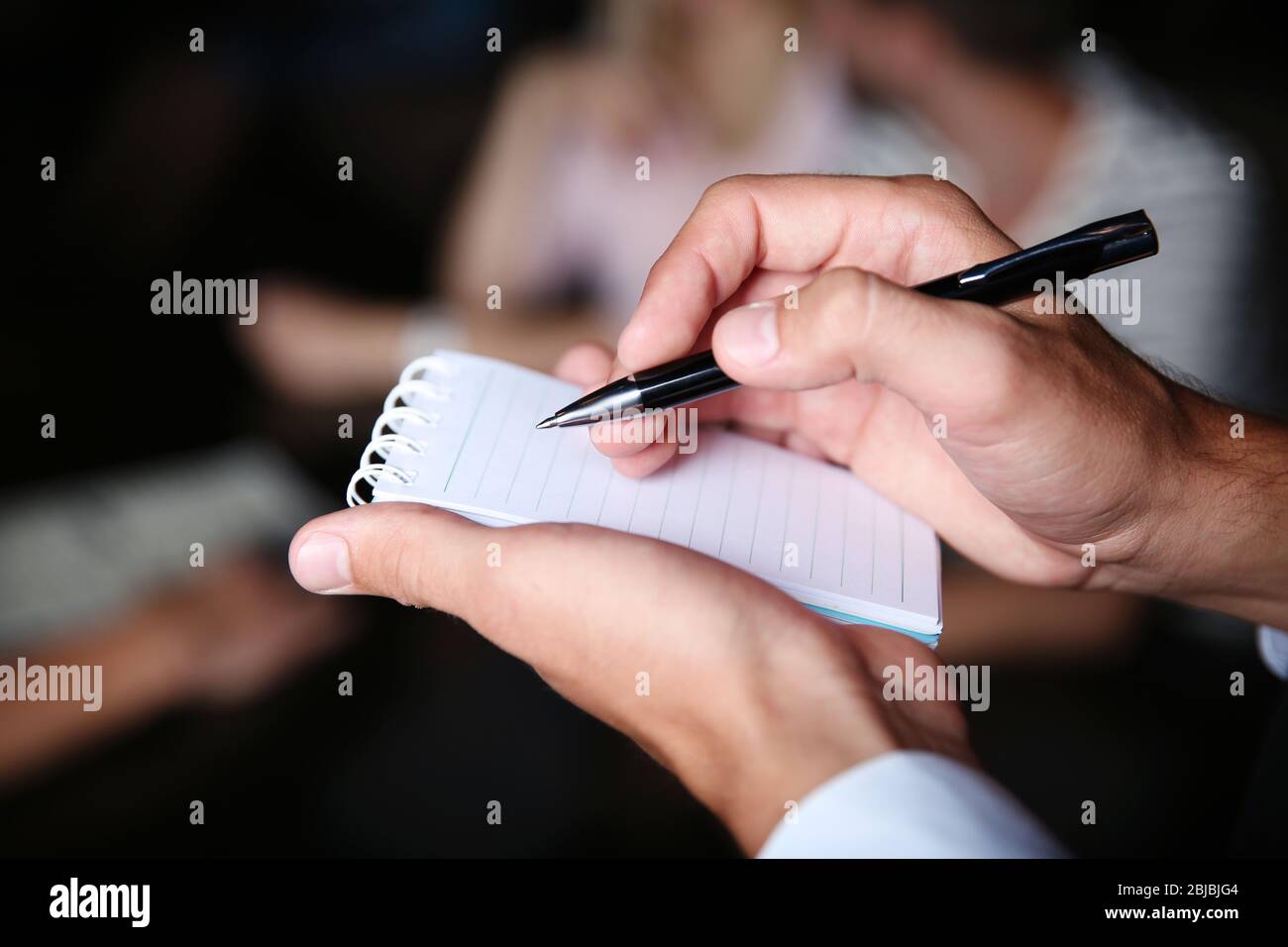 Waiter writing an order into a notebook Stock Photo - Alamy