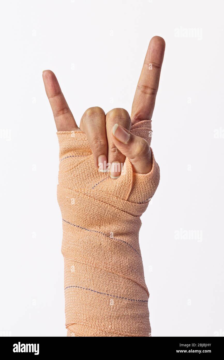 Broken female wrist Rock gesture, strong, powerful, respect sign. Stock Photo